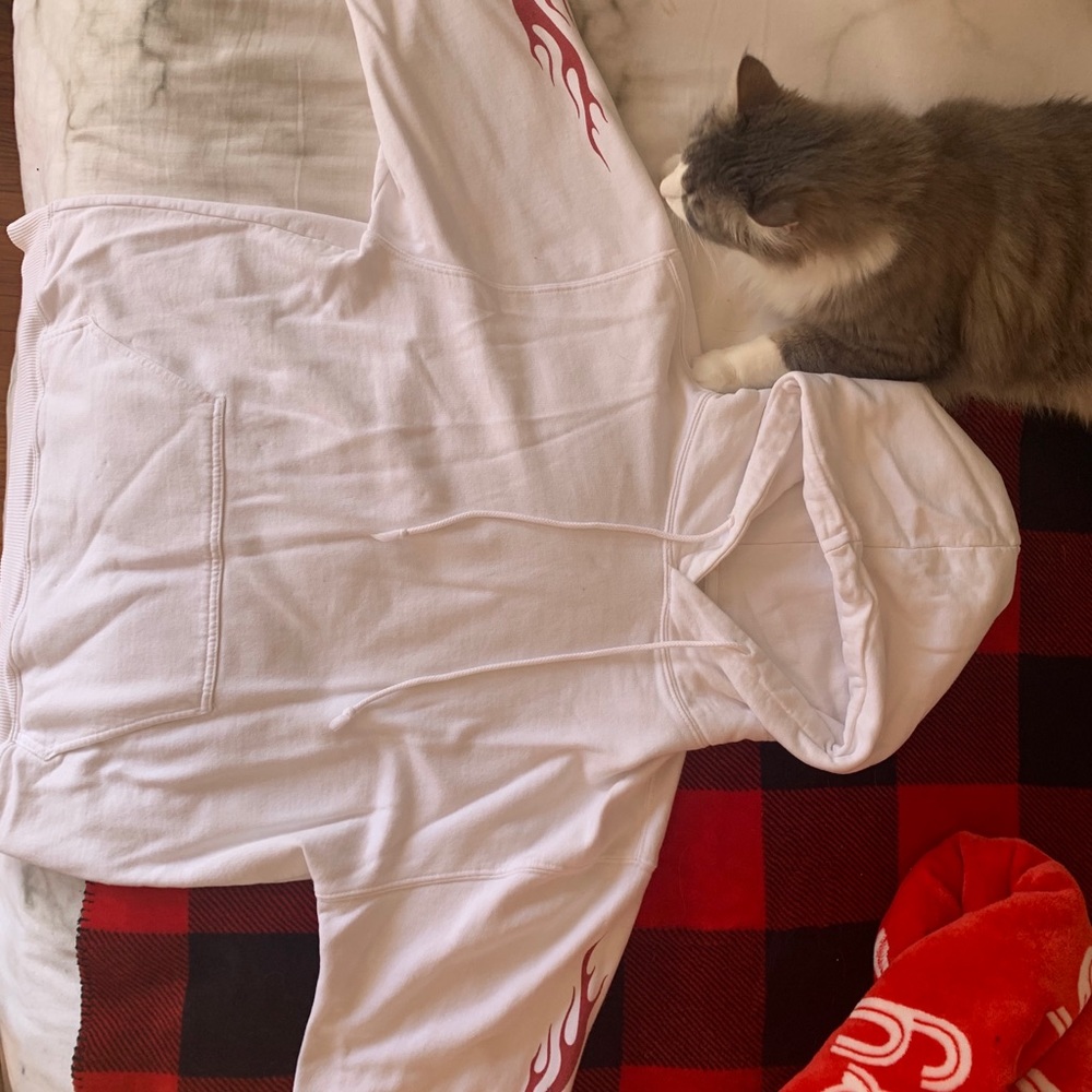 White hoodie with red flames on sleeves